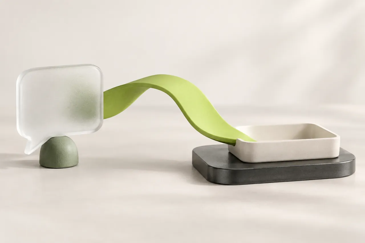 An unbroken lime ceramic ribbon connects a blank frosted-glass speech tile to an open ivory tray.
