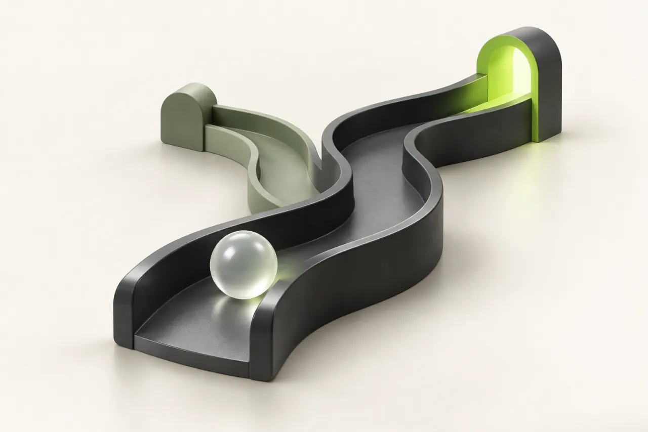 A glass sphere travels through a sculptural channel toward a lime opening in a graphite structure.